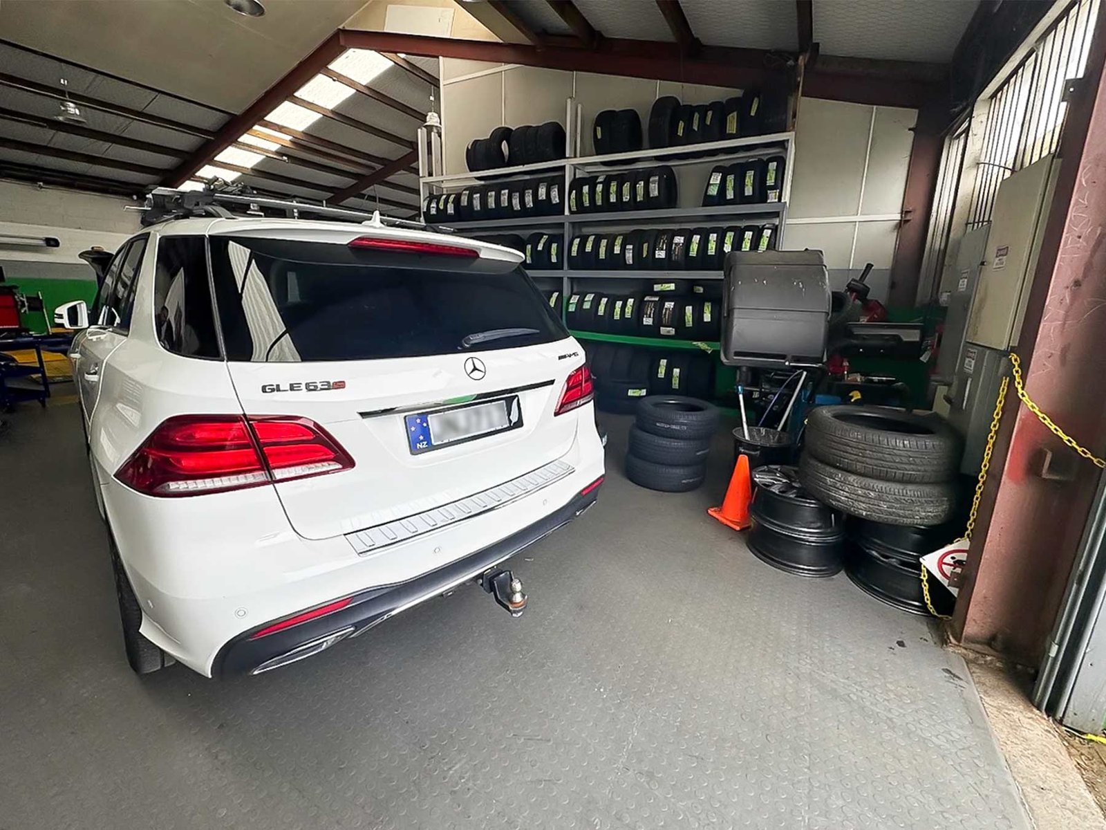 white car in tyre section of workshop