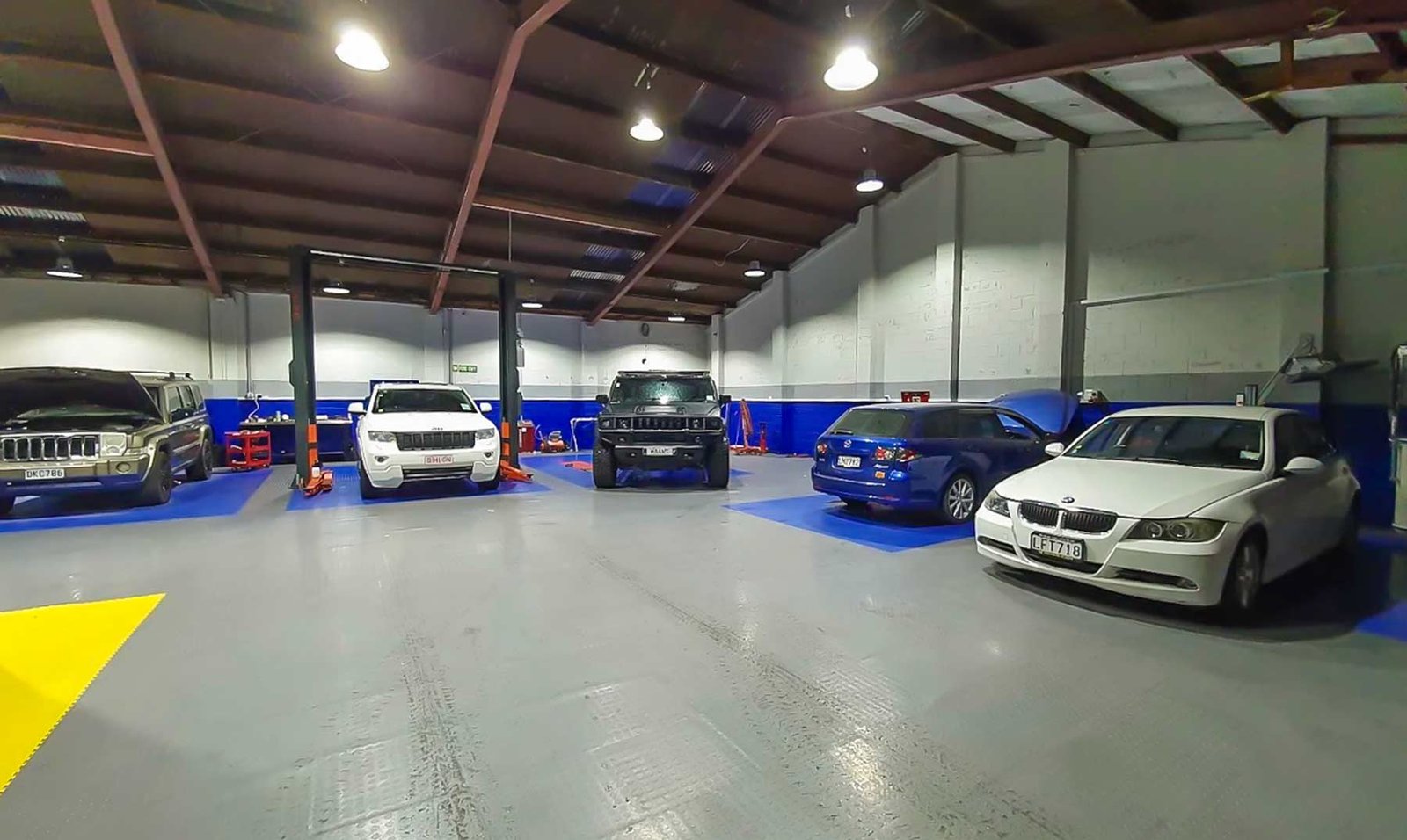 inside business garage, tidy with several cars parked