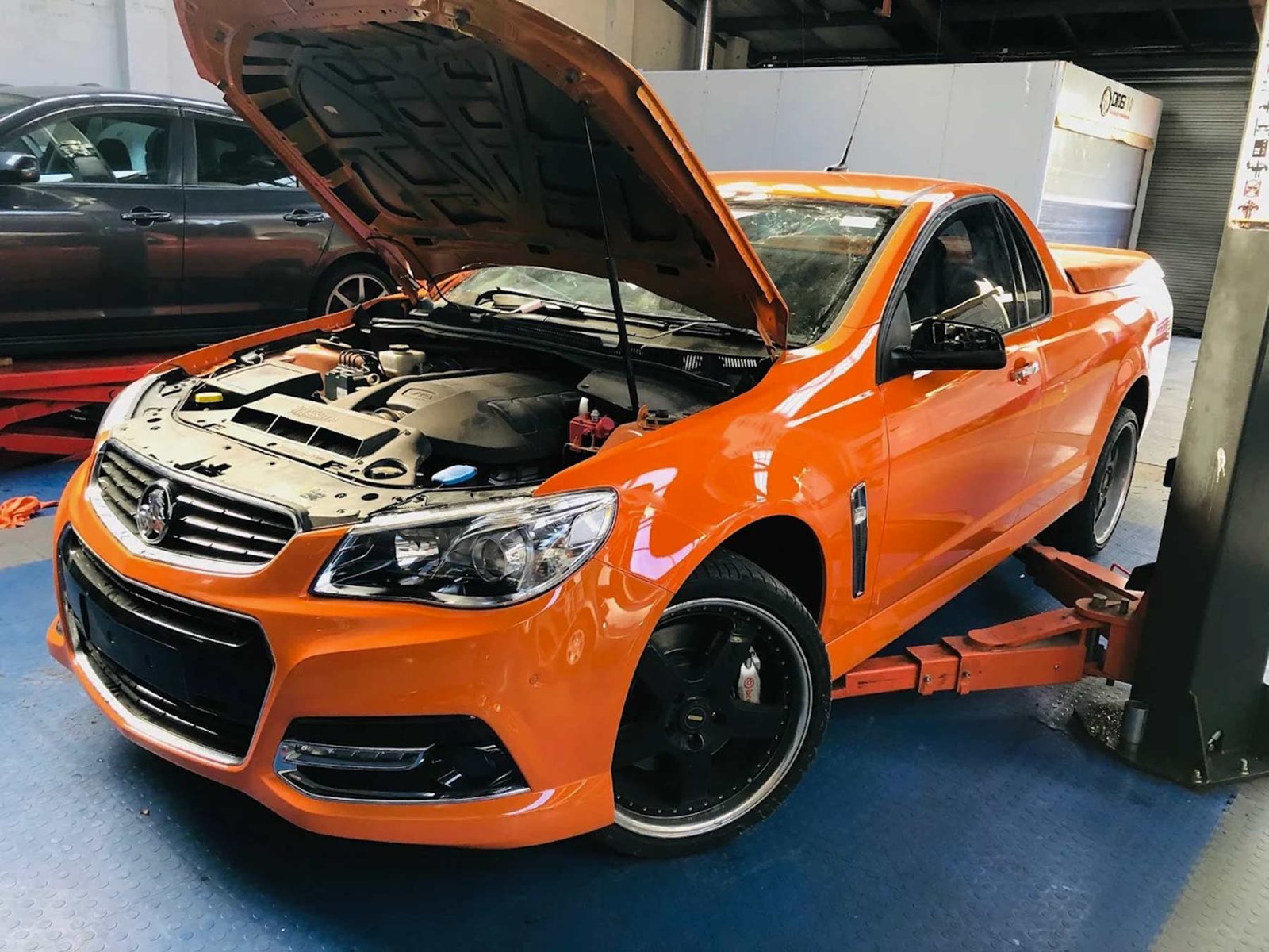 orange holden with bonnet open