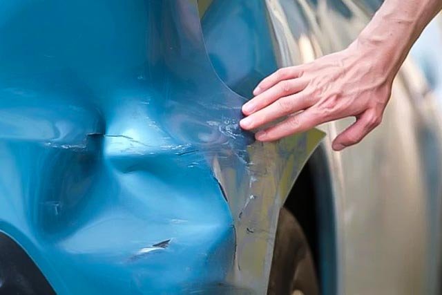 white car in tyre section of workshop
