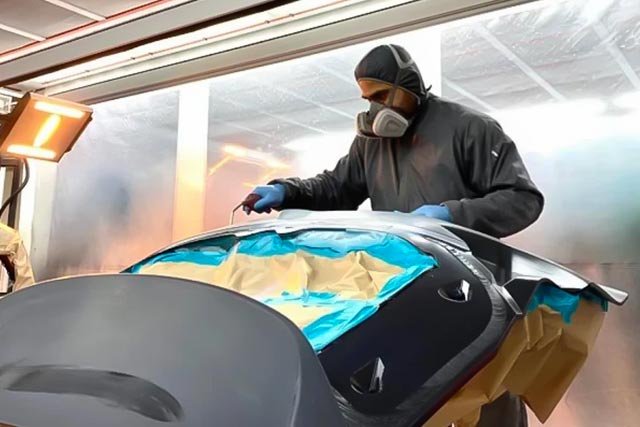 orange holden with bonnet open