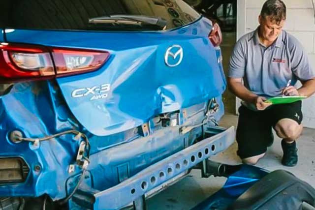 orange holden with bonnet open