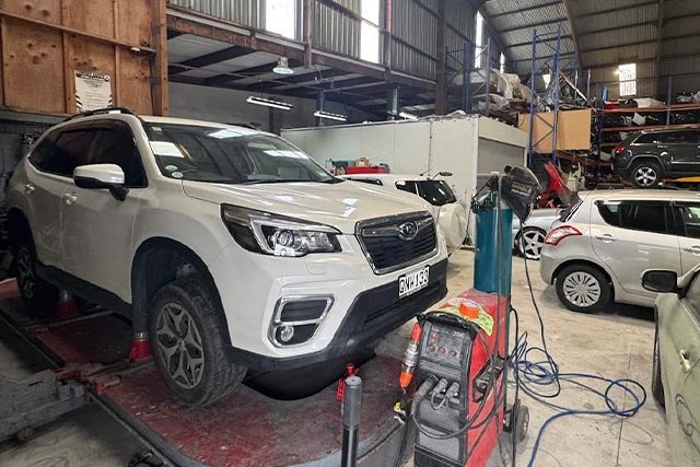 white car in tyre section of workshop