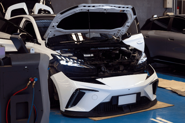 3 white car in tyre section of workshop