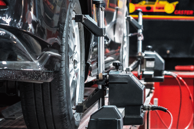 Untitled (640 x 427 px) (1) white car in tyre section of workshop